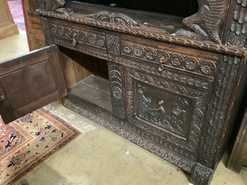 A late 19th century Flemish carved oak cabinet, width 145cm depth 48cm height 190cm